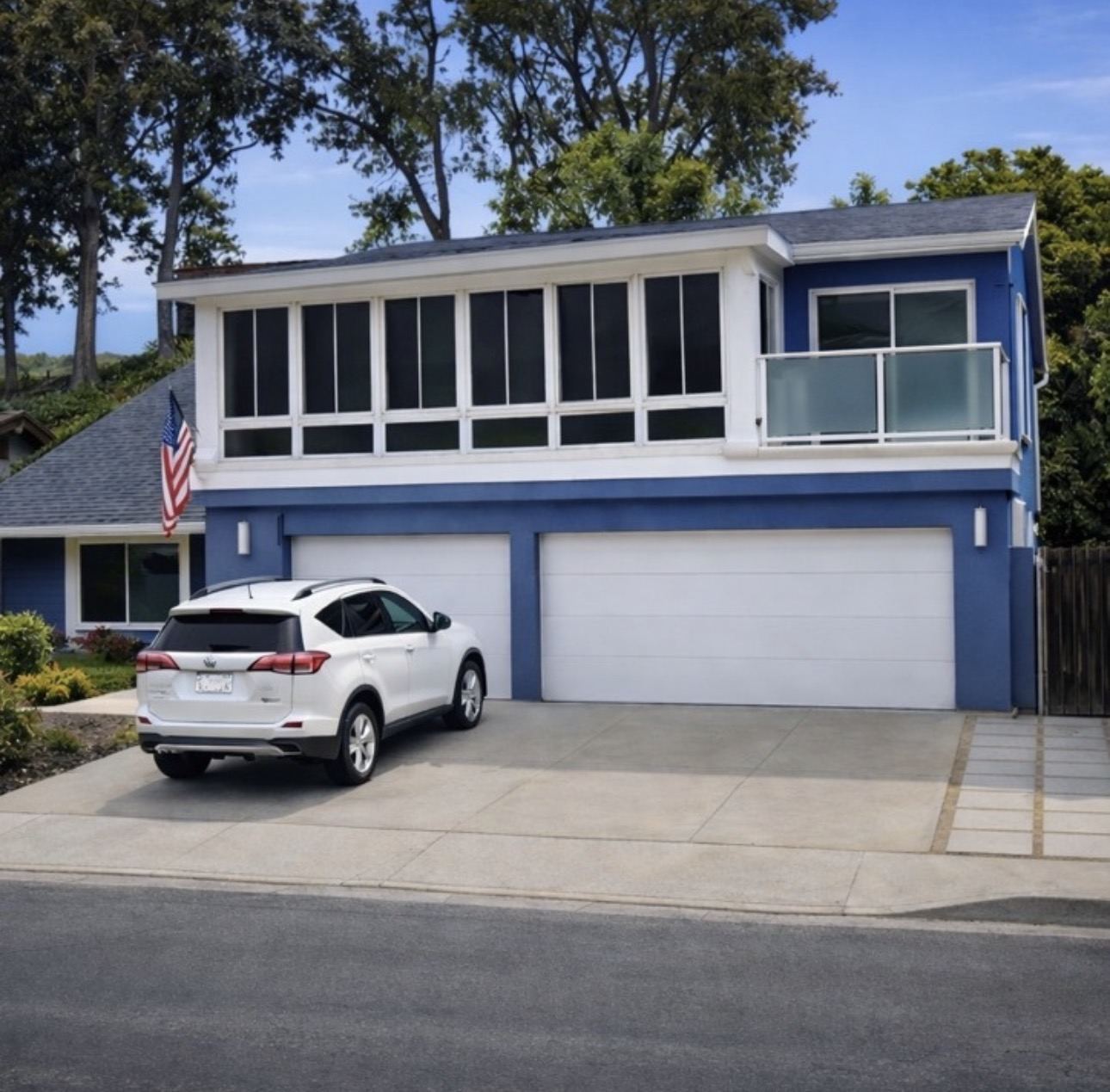 Second-story room addition above a garage with wrap-around windows, San Diego